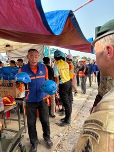 U.S. Military personnel from U.S. Indo-Pacific Command meet with first responders at the Search and Rescue Operations Center near the collapsed State Audit Office building in Bangkok, which fell after a 7.7 earthquake hit Thailand and its neighbor countries on March 28, 2025.
