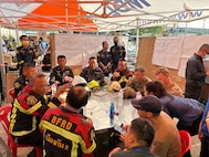 U.S. Military personnel from U.S. Indo-Pacific Command meet with first responders at the Search and Rescue Operations Center near the collapsed State Audit Office building in Bangkok, which fell after a 7.7 earthquake hit Thailand and its neighbor countries on March 28, 2025.