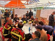 U.S. Military personnel from U.S. Indo-Pacific Command meet with first responders at the Search and Rescue Operations Center near the collapsed State Audit Office building in Bangkok, which fell after a 7.7 earthquake hit Thailand and its neighbor countries on March 28, 2025.