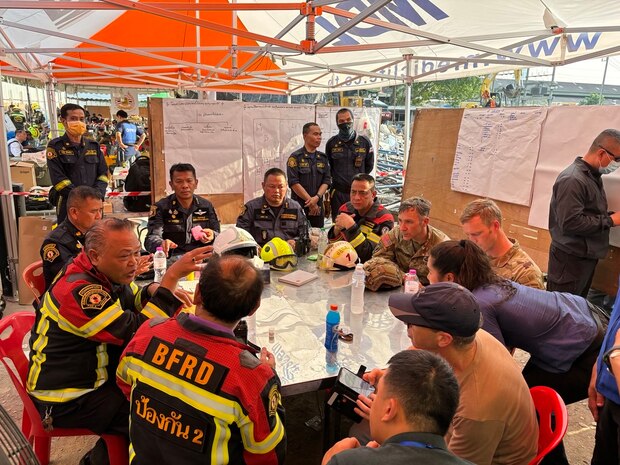 U.S. Military personnel from U.S. Indo-Pacific Command meet with first responders at the Search and Rescue Operations Center near the collapsed State Audit Office building in Bangkok, which fell after a 7.7 earthquake hit Thailand and its neighbor countries on March 28, 2025.