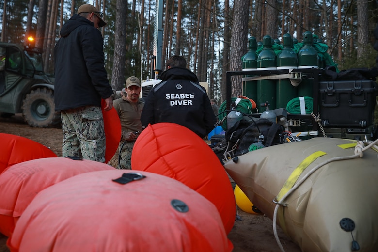 Members of Commander, Task Force (CTF) 68, a U.S. Navy dive team, begin diving operations in support of efforts to find four U.S. soldiers in a submerged M88 Hercules recovery vehicle at a training site near Pabradė, Lithuania, March 29, 2025.