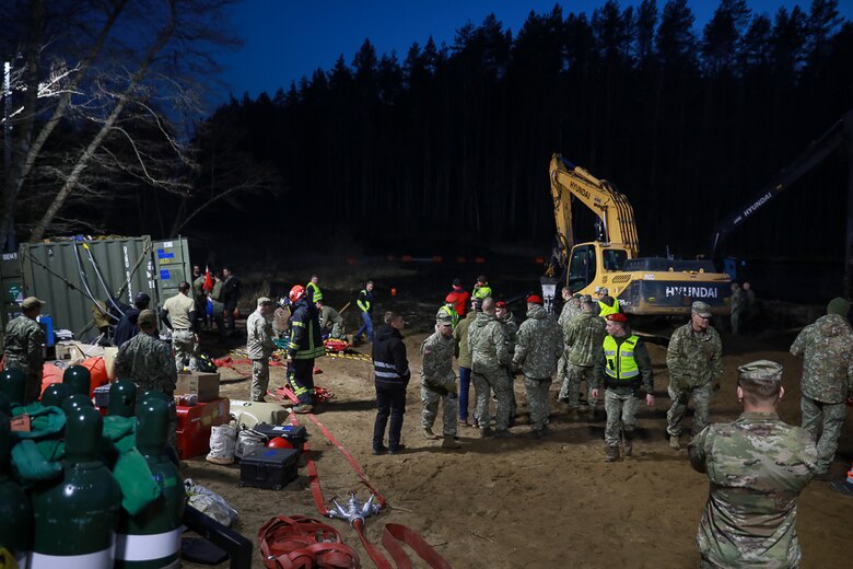 Members of Commander, Task Force (CTF) 68, a U.S. Navy dive team, begin diving operations in support of efforts to find four U.S. soldiers in a submerged M88 Hercules recovery vehicle at a training site near Pabradė, Lithuania, March 29, 2025.