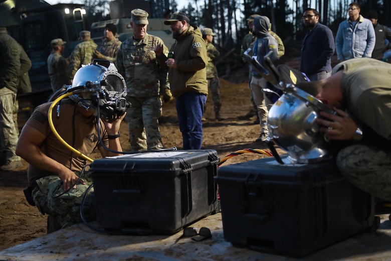 Members of Commander, Task Force (CTF) 68, a U.S. Navy dive team, begin diving operations in support of efforts to find four U.S. soldiers in a submerged M88 Hercules recovery vehicle at a training site near Pabradė, Lithuania, March 29, 2025.