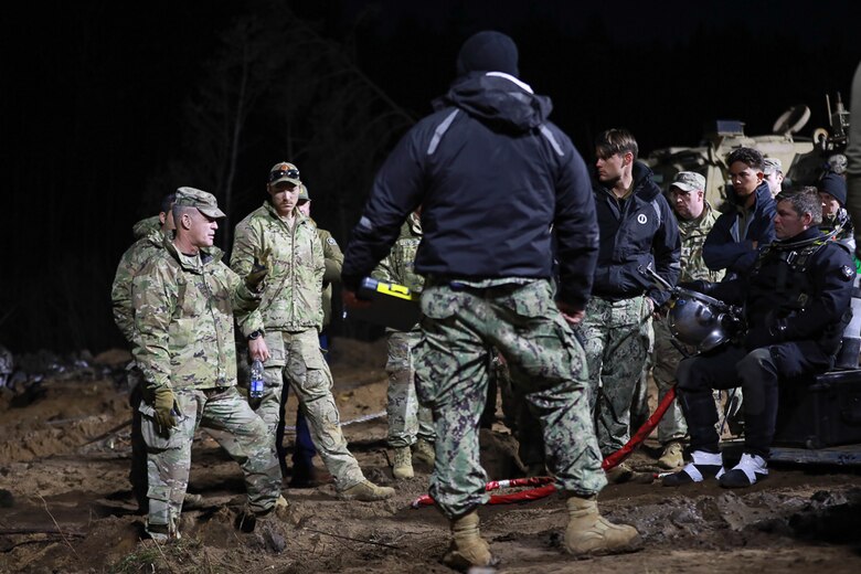 Members of Commander, Task Force (CTF) 68, a U.S. Navy dive team, begin diving operations in support of efforts to find four U.S. soldiers in a submerged M88 Hercules recovery vehicle at a training site near Pabradė, Lithuania, March 29, 2025.