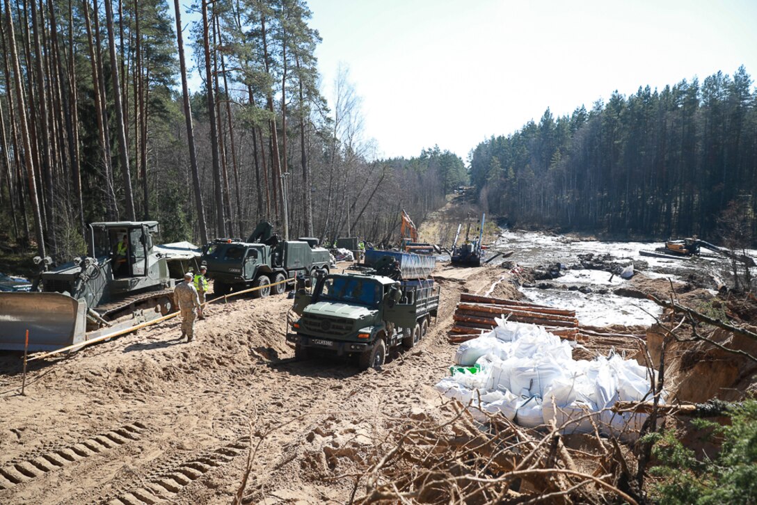 U.S. Army soldiers, Lithuanian army soldiers and emergency services gather to provide assistance during a recovery operation near Pabradė, Lithuania, March 29, 2025.