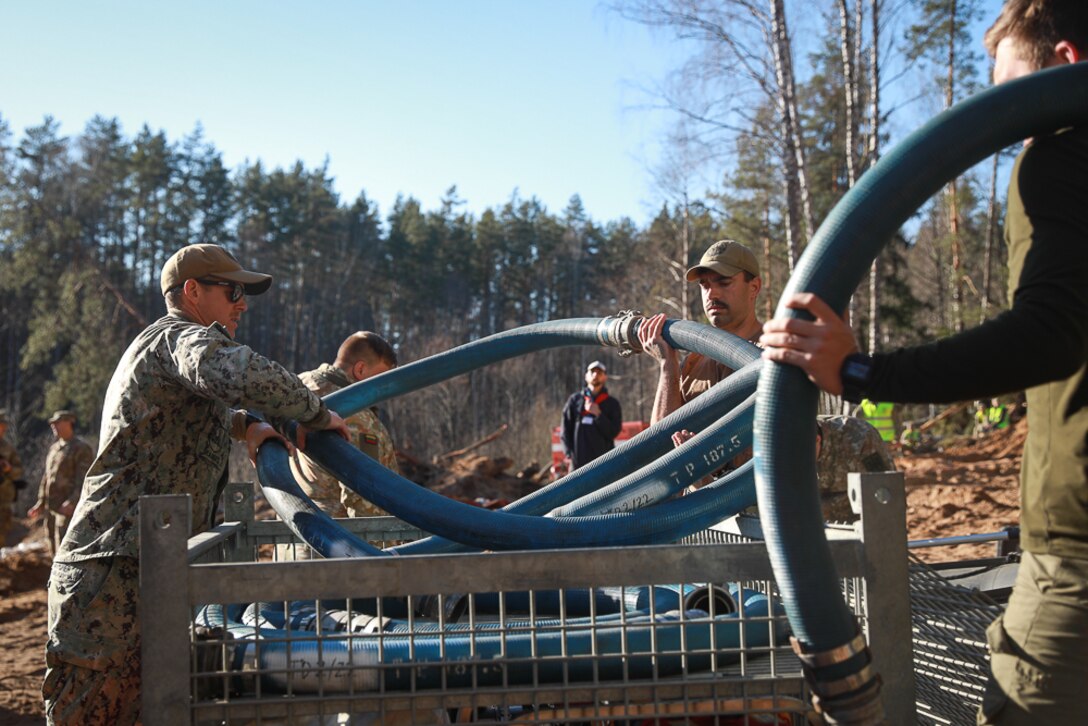 Members of Commander, Task Force (CTF) 68, a U.S. Navy dive team, begin diving operations in support of efforts to find four U.S. soldiers in a submerged M88 Hercules recovery vehicle at a training site near Pabradė, Lithuania, March 29, 2025.