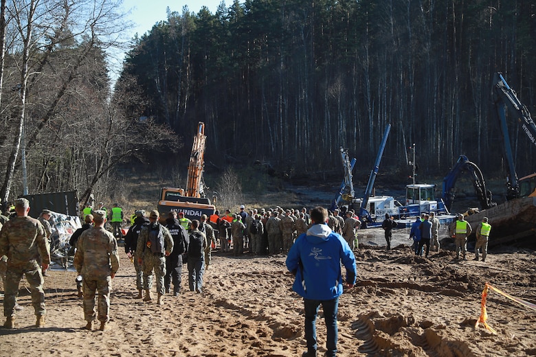 U.S. Army soldiers, Lithuanian Armed Forces and emergency services gather to provide assistance during a recovery operation near Pabradė, Lithuania, March 29, 2025.