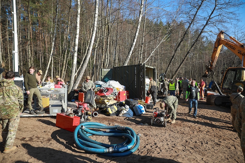 Members of Commander, Task Force (CTF) 68, a U.S. Navy dive team, begin diving operations in support of efforts to find four U.S. soldiers in a submerged M88 Hercules recovery vehicle at a training site near Pabradė, Lithuania, March 29, 2025.