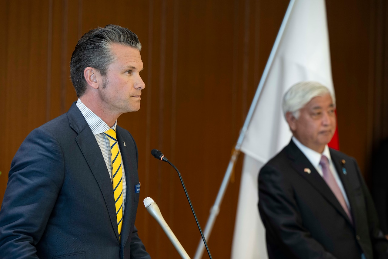 A side view of men speaking from podiums.