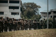 U.S. Marines with 1st Battalion, 5th Marine Regiment, 1st Marine Division, attached to Marine Rotational Force-Southeast Asia, alongside Singapore Guardsmen with 3rd Battalion Singapore Guards, 7th Singapore Infantry Brigade, stand-by for the closing ceremony for Valiant Mark 25 at SAFTI City training facility, Singapore, March 27, 2025.