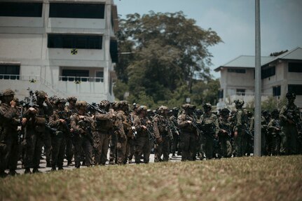 U.S. Marines with 1st Battalion, 5th Marine Regiment, 1st Marine Division, attached to Marine Rotational Force-Southeast Asia, alongside Singapore Guardsmen with 3rd Battalion Singapore Guards, 7th Singapore Infantry Brigade, stand-by for the closing ceremony for Valiant Mark 25 at SAFTI City training facility, Singapore, March 27, 2025.