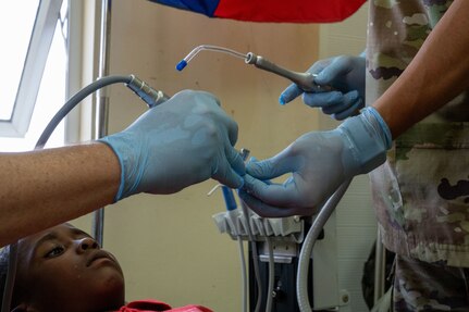 U.S. Air Force Col. Michael Bates, 433rd Aerospace Medicine Squadron (AMDS) dentist, left, and Senior Airman Joshua Antonio Moreno, 433rd AMDS dental technician, right, prepare toothpaste for a teeth cleaning procedure during the Lesser Antilles Medical Assistance Team (LAMAT) 2025 mission at Celina Clouden Smart Hospital, Union Island, Saint Vincent and the Grenadines, March 20, 2025.