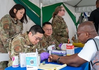 U.S. Air Force medical professionals from the 433rd Aerospace Medicine Squadron conduct blood sugar screenings during the Lesser Antilles Medical Assistance Team (LAMAT) 2025 health fair at Kingstown, Saint Vincent and the Grenadines, March 20, 2025.