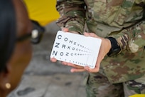 U.S. Air Force Maj. Monica Bentley, 433rd Aerospace Medicine Squadron optometrist, conducts a vision screening during the Lesser Antilles Medical Assistance Team (LAMAT) 2025 health fair at Kingstown, Saint Vincent and the Grenadines, March 20, 2025.