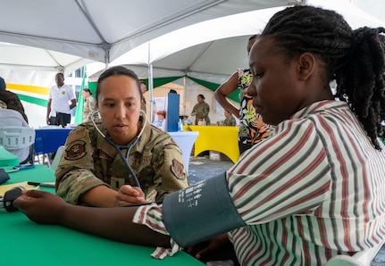 U.S. Air Force 1st Lt. Dana Macabales, 349th  Medical Squadron intensive care unit nurse, performs a blood pressure check for a local resident during the Lesser Antilles Medical Assistance Team (LAMAT) 2025 health fair at Kingstown, Saint Vincent and the Grenadines, March 20, 2025.