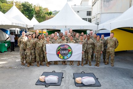 The U.S. Air Force St. Vincent Lesser Antilles Medical Assistance Team (LAMAT)  poses for a group photo before the start of a health fair at Kingstown, Saint Vincent and the Grenadines, March 20, 2025.