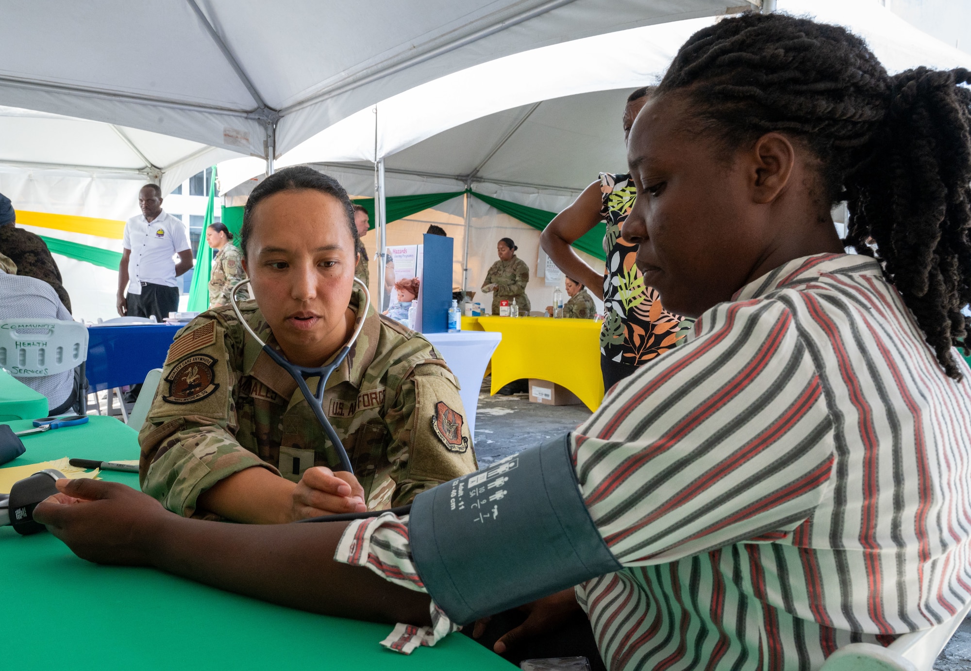 U.S. Air Force 1st Lt. Dana Macabales, 349th  Medical Squadron intensive care unit nurse, performs a blood pressure check for a local resident during the Lesser Antilles Medical Assistance Team (LAMAT) 2025 health fair at Kingstown, Saint Vincent and the Grenadines, March 20, 2025.