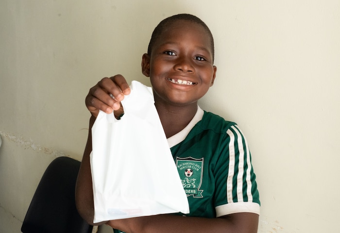 A young island resident smiles for a photo as he holds a dental hygiene kit provided by U.S. Air Force dental personnel during the Lesser Antilles Medical Assistance Team (LAMAT) 2025 mission at Celina Clouden Smart Hospital, Union Island, Saint Vincent and the Grenadines, March 20, 2025.