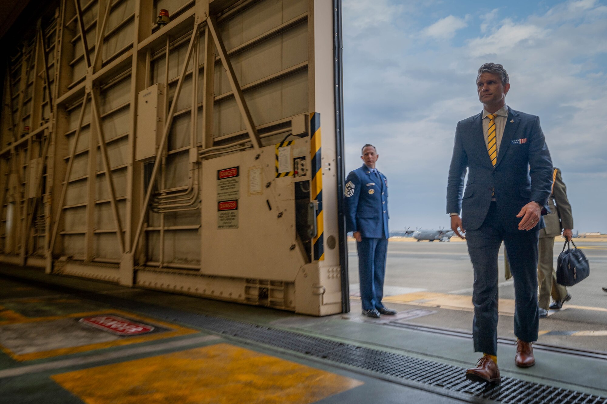 SECDEF enters hangar.