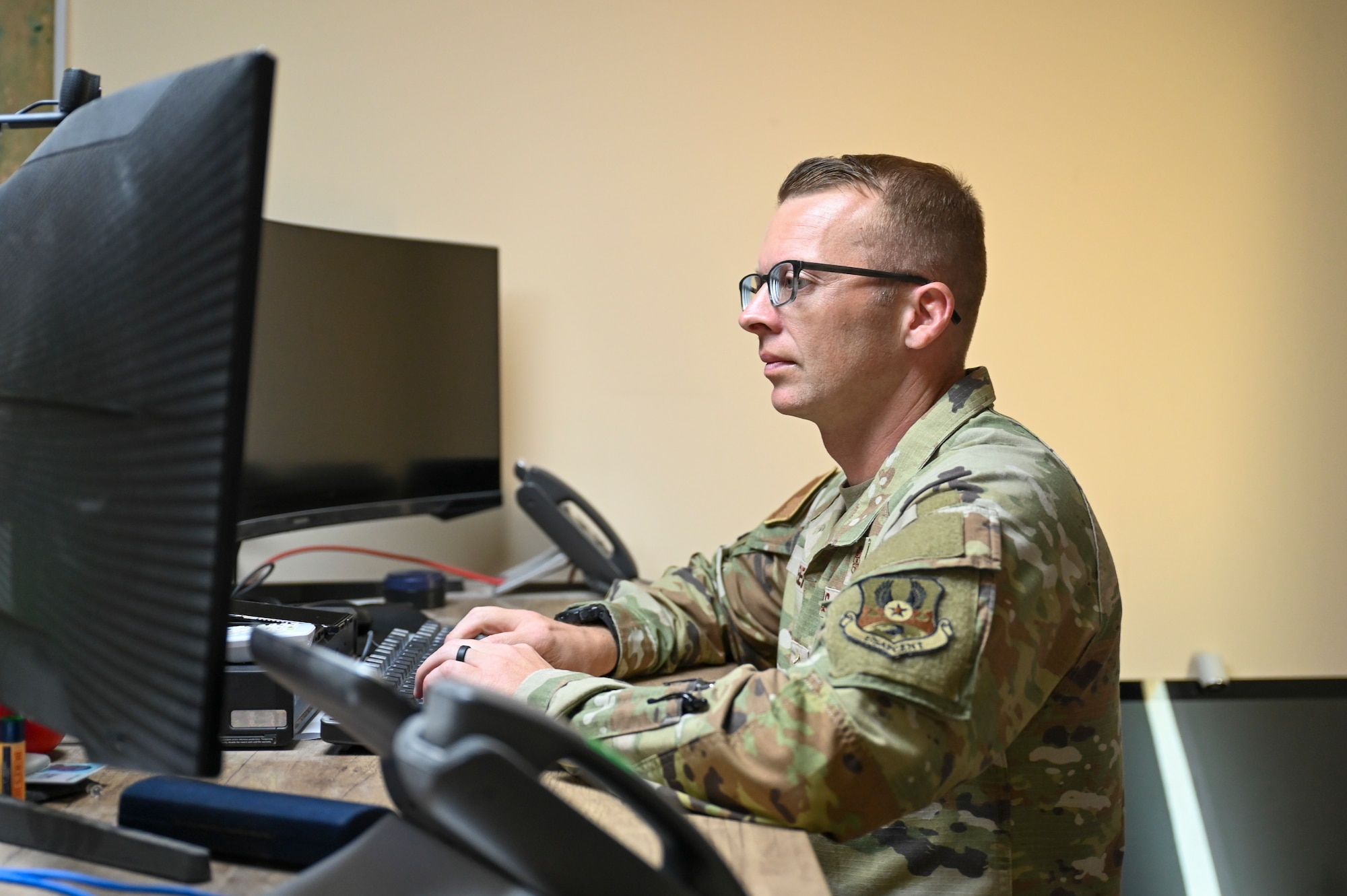 U.S. Air Force Chief Master Sgt. Steven Creek, 378th Air Expeditionary Wing command chief, works on his computer in the U.S. Central Command area of responsibility, March 18, 2024.