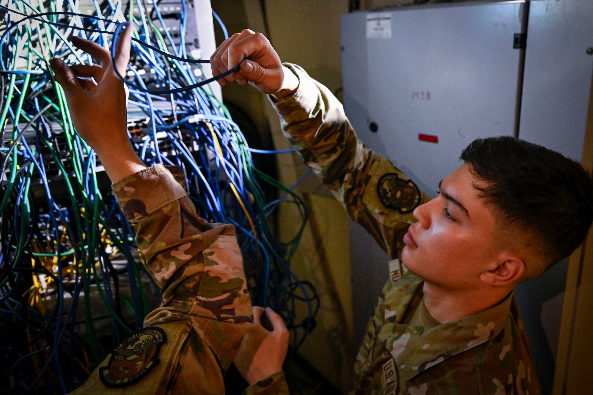 An Airman troubleshoots network connections.