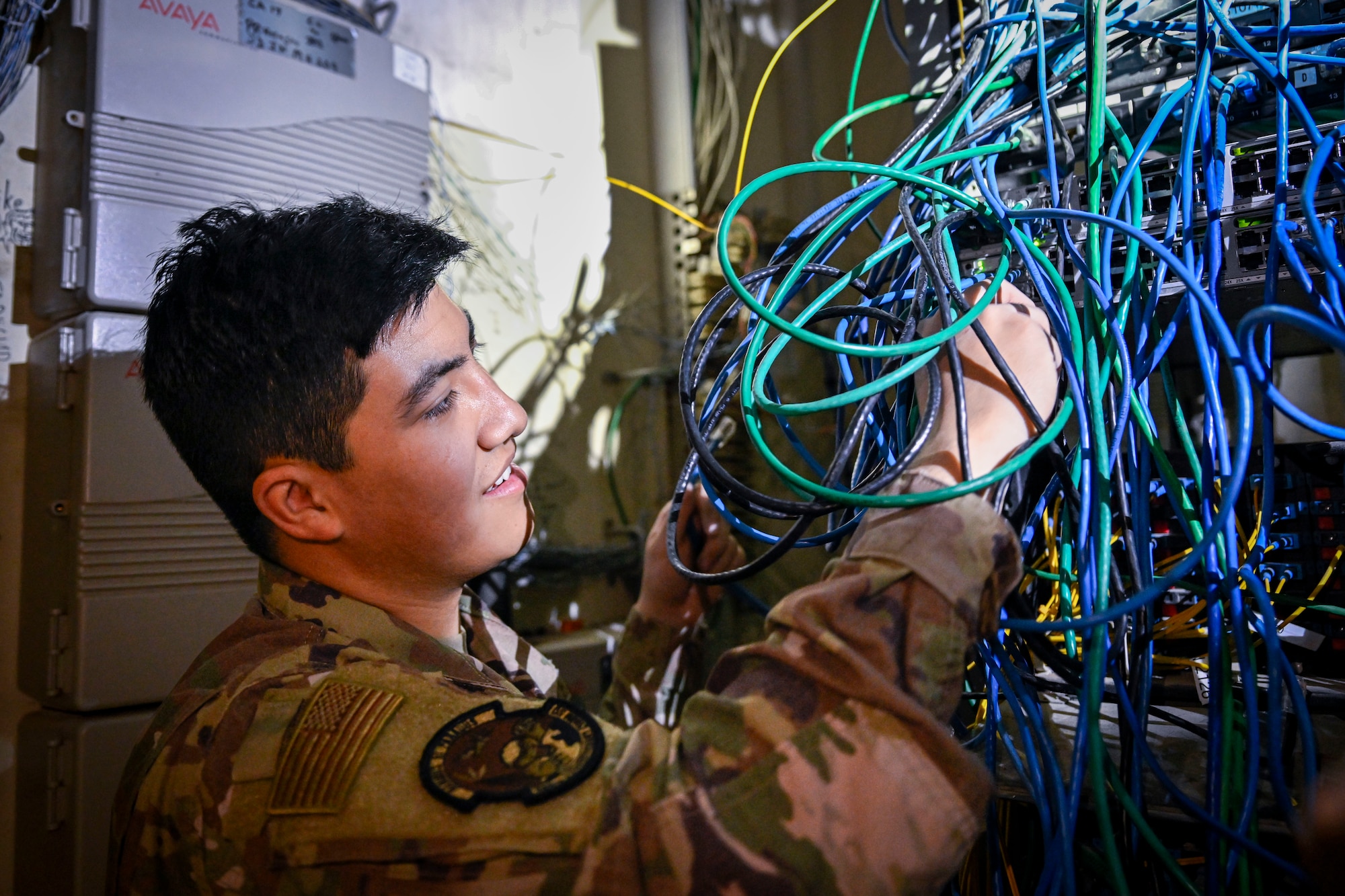 An Airman troubleshoots network connections.