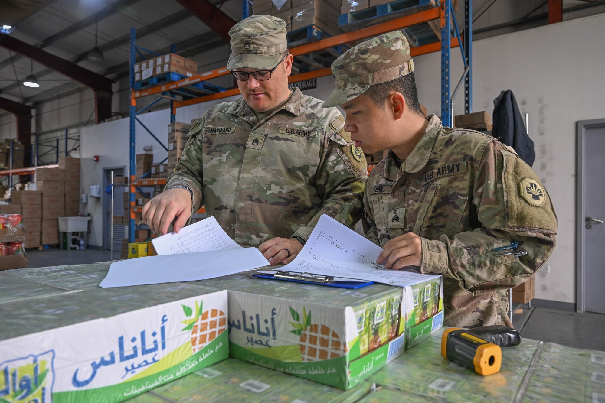 Men in uniform look at paperwork.