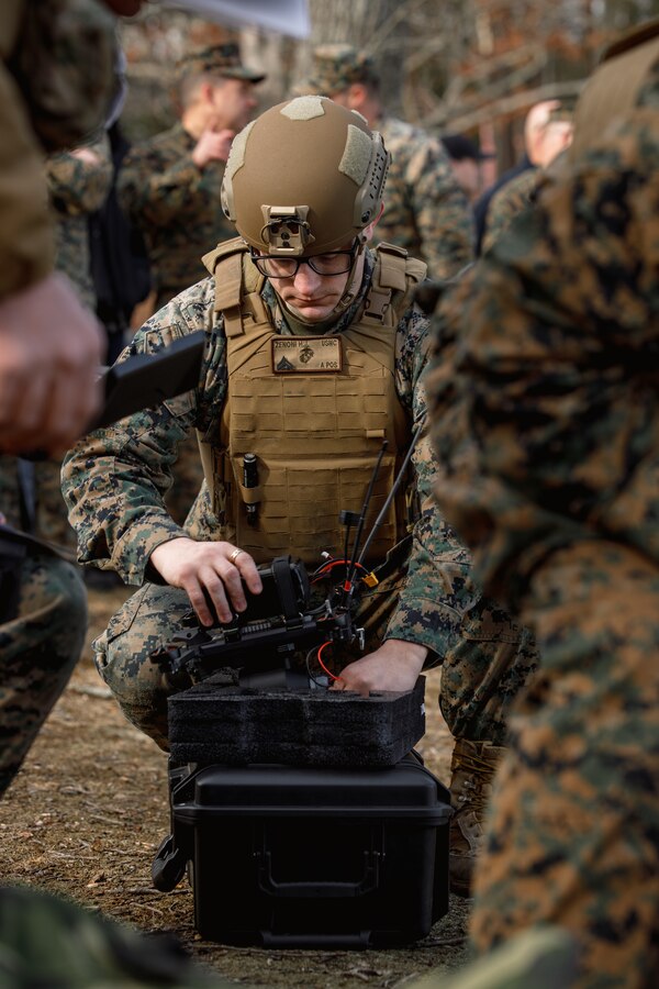 U.S. Marine Corps. Cpl. Hunter J. Zenoni, a precision weapons technician, and first-person-view drone operator with the Marine Corps Attack Drone Team, Weapons Training Battalion, picks up a Neros Archer first-person view drone during a demonstration range at WTBn on Marine Corps Base Quantico, Virginia, March 7, 2025. The Marine Corps Attack Drone Team conducted a demonstration range to showcase their capabilities as a team and how they can be used on the battlefield. (U.S. Marine Corps photo by Cpl. Joshua Barker)