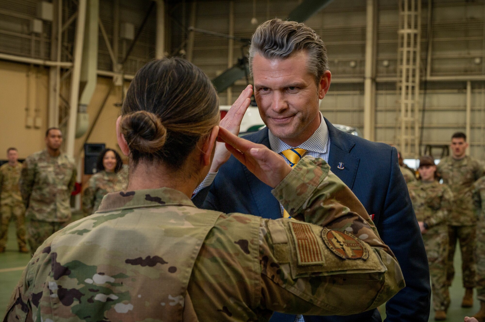 SECDEF renders a salute back to an Airman.