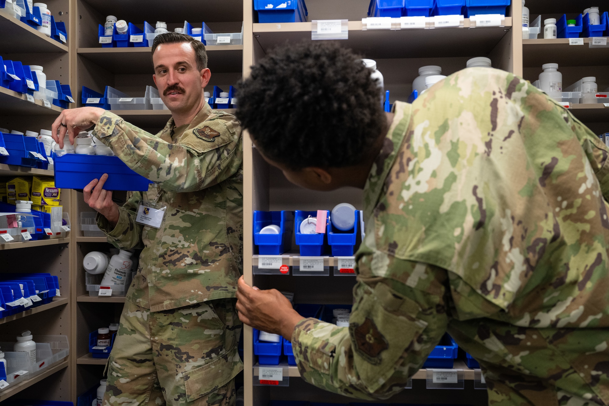 Tech. Sgt. Carl Miller, 7th Operations Support Squadron intelligence training flight chief, and Airman J’Shan Killingsworth, 7th OSS all source analyst, assist the 7th Medical Group with pharmacy operations at Dyess Air Force Base, Texas, March 26, 2025. Participating 7th Operations Group Airmen completed additional training to support the 7th MDG pharmacy. (U.S. Air Force photo by Airman 1st Class Jade M. Caldwell)