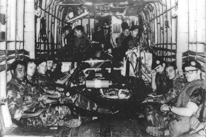 Airmen are inside a helicopter.