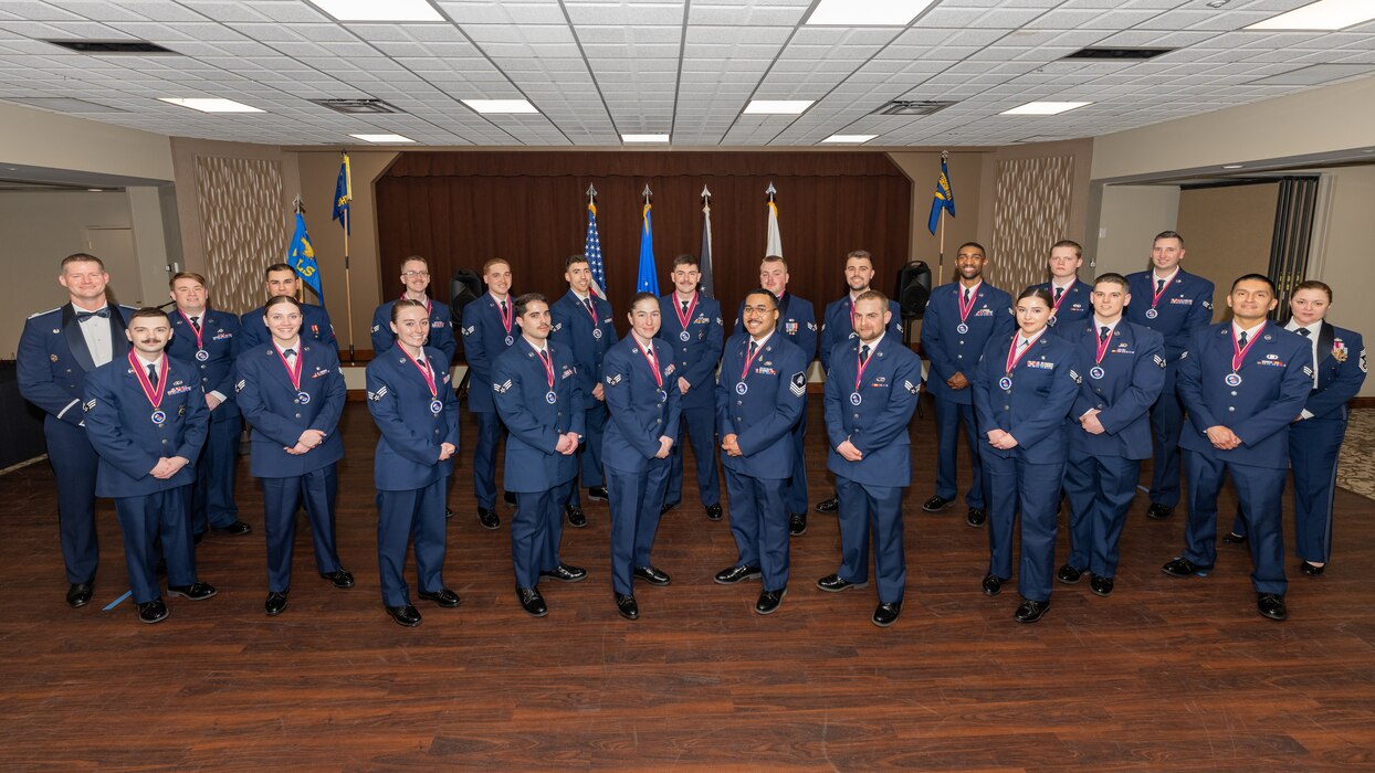 A large group photo of service members wearing formal and semi-formal military service dress uniforms