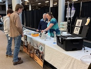 Ann Thomas, a biomedical equipment technician with the U.S. Army Medical Materiel Agency’s Medical Maintenance Operations Division at Tobyhanna Army Depot, demonstrates how to use a medical device to a group of students during the “Explore to Know More” event March 19 at the Pennsylvania depot. Also pictured is George Takacs, MMOD-PA chief of operations. The first-ever event drew about 90 students from nearby high schools and colleges to learn about the depot’s mission and various technical and academic career fields available.