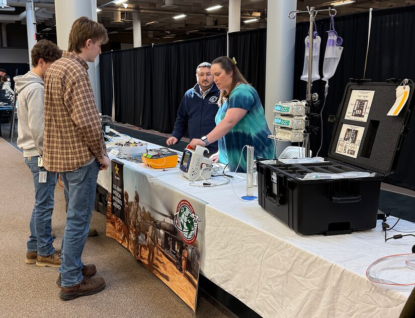 Ann Thomas, a biomedical equipment technician with the U.S. Army Medical Materiel Agency’s Medical Maintenance Operations Division at Tobyhanna Army Depot, demonstrates how to use a medical device to a group of students during the “Explore to Know More” event March 19 at the Pennsylvania depot. Also pictured is George Takacs, MMOD-PA chief of operations. The first-ever event drew about 90 students from nearby high schools and colleges to learn about the depot’s mission and various technical and academic career fields available.