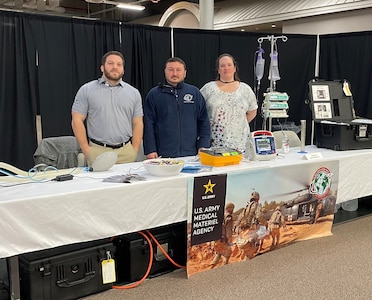 From left, Mike Tagliaferri, George Takacs and Ann Thomas are pictured at the U.S. Army Medical Materiel Agency’s booth during the “Explore to Know More” event at Tobyhanna Army Depot, Pennsylvania. The team at USAMMA’s Medical Maintenance Operations Division at Tobyhanna showcased the medical maintenance career field during the two-day event.