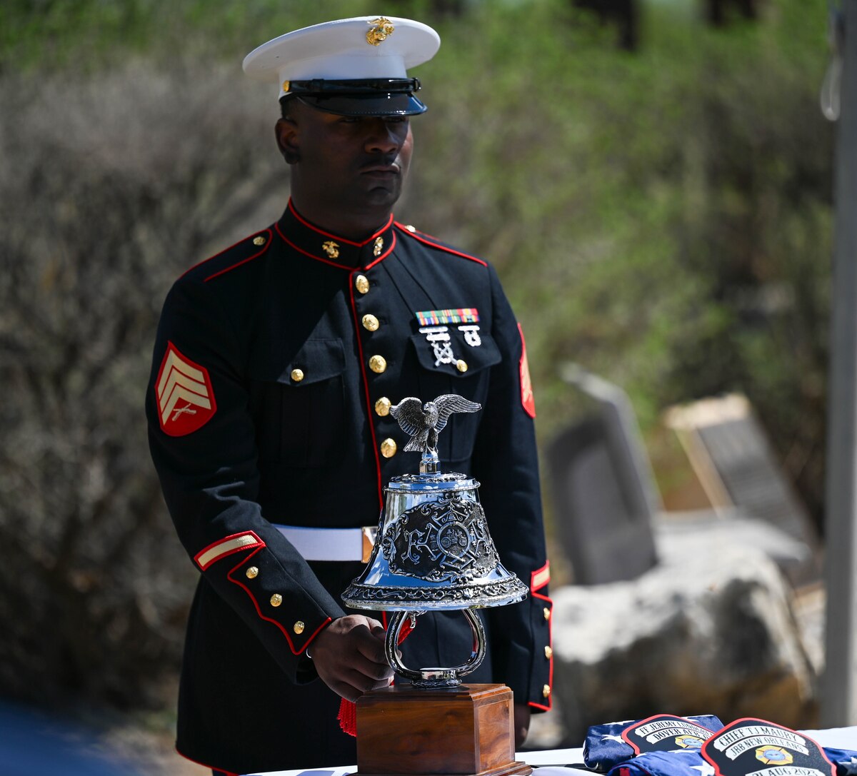 U.S. Marine Corps Sgt. Steven Brooks, Marine Corps Detachment Goodfellow Air Force Base Fire Company instructor, rings the ceremonial bell during the final call at the annual Department of Defense Fallen Firefighter Memorial Service at the Fire Protection Heritage Pathway, Goodfellow Air Force Base, Texas, March 28, 2025. The ceremonial bell was rung eight times as a send-off to the firefighters who had laid down their lives in the line of duty. (U.S. Air Force photo by Staff Sgt. Nathan Call)
