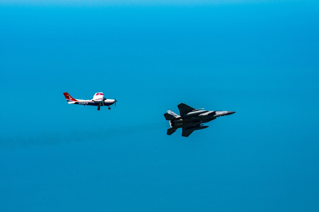 An F-15 fighter jet from the Florida Air National Guard’s 125th Fighter Wing, Detachment 1, intercepted a simulated Temporary Flight Restriction violator during a demonstration near Homestead Air Reserve Base, Florida, March 26, 2025. The exercise, coordinated with a Civil Air Patrol Cessna, highlighted the importance of TFR compliance and the teamwork and precision of NORAD pilots tasked with protecting North American airspace.