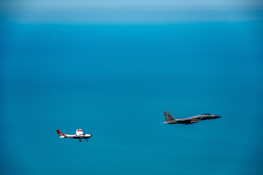 An F-15 fighter jet from the Florida Air National Guard’s 125th Fighter Wing, Detachment 1, intercepted a simulated Temporary Flight Restriction violator during a demonstration near Homestead Air Reserve Base, Florida, March 26, 2025. The exercise, coordinated with a Civil Air Patrol Cessna, highlighted the importance of TFR compliance and the teamwork and precision of NORAD pilots tasked with protecting North American airspace.
