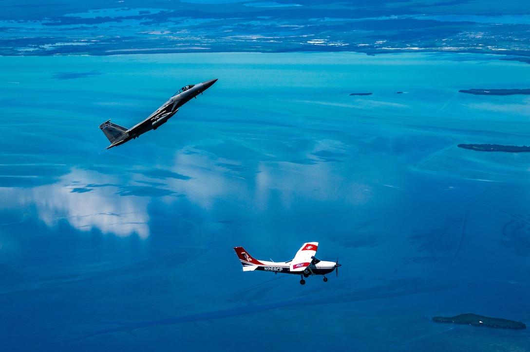 An F-15 fighter jet from the Florida Air National Guard’s 125th Fighter Wing, Detachment 1, intercepted a simulated Temporary Flight Restriction violator during a demonstration near Homestead Air Reserve Base, Florida, March 26, 2025. The exercise, coordinated with a Civil Air Patrol Cessna, highlighted the importance of TFR compliance and the teamwork and precision of NORAD pilots tasked with protecting North American airspace.