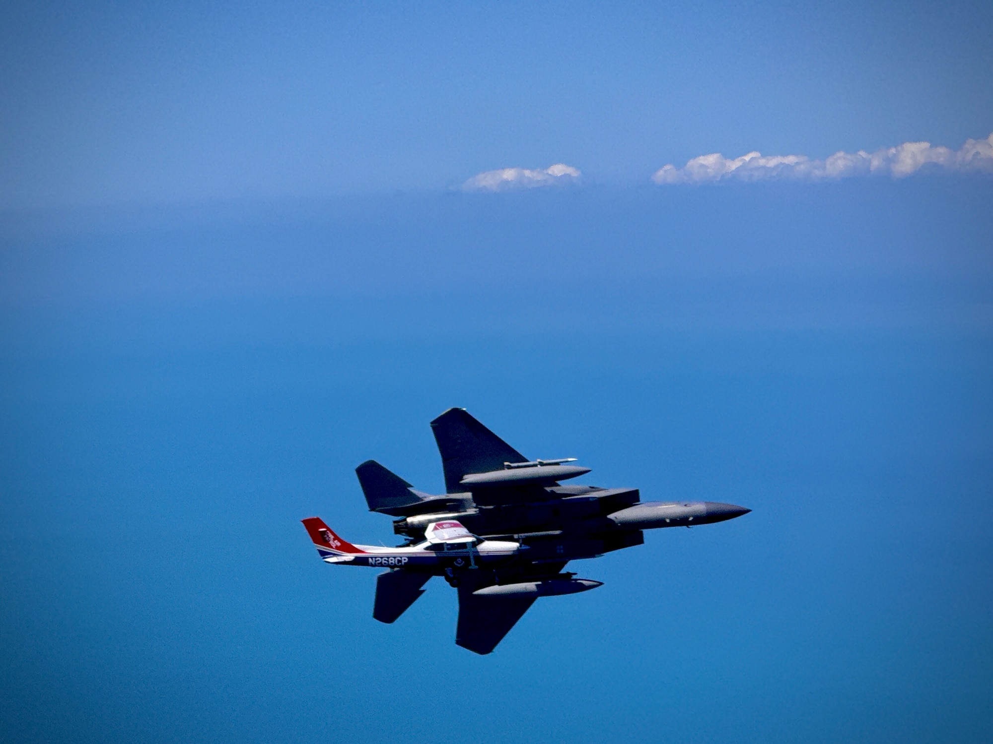 An F-15 fighter jet from the Florida Air National Guard’s 125th Fighter Wing, Detachment 1, intercepted a simulated Temporary Flight Restriction violator during a demonstration near Homestead Air Reserve Base, Florida, March 26, 2025. The exercise, coordinated with a Civil Air Patrol Cessna, highlighted the importance of TFR compliance and the teamwork and precision of NORAD pilots tasked with protecting North American airspace.