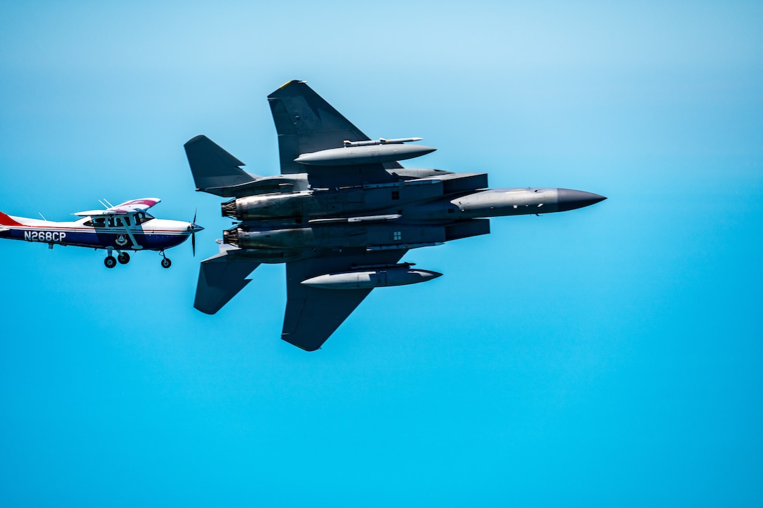 An F-15 fighter jet from the Florida Air National Guard’s 125th Fighter Wing, Detachment 1, intercepted a simulated Temporary Flight Restriction violator during a demonstration near Homestead Air Reserve Base, Florida, March 26, 2025. The exercise, coordinated with a Civil Air Patrol Cessna, highlighted the importance of TFR compliance and the teamwork and precision of NORAD pilots tasked with protecting North American airspace.
