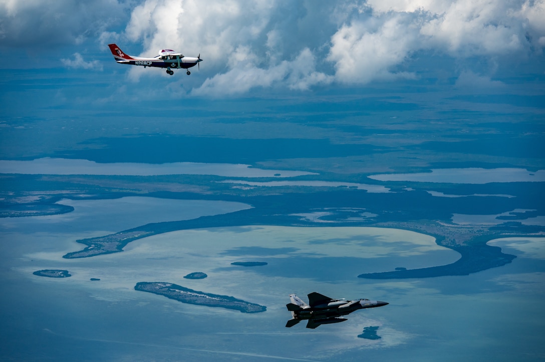An F-15 fighter jet from the Florida Air National Guard’s 125th Fighter Wing, Detachment 1, intercepted a simulated Temporary Flight Restriction violator during a demonstration near Homestead Air Reserve Base, Florida, March 26, 2025. The exercise, coordinated with a Civil Air Patrol Cessna, highlighted the importance of TFR compliance and the teamwork and precision of NORAD pilots tasked with protecting North American airspace.