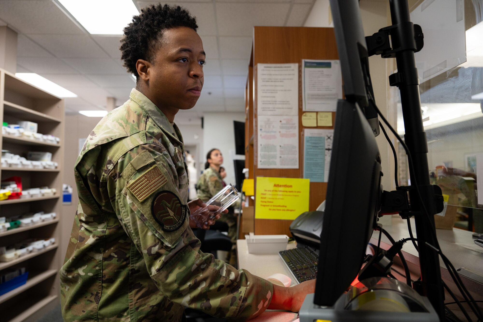 Airman J’Shan Killingsworth, 7th Operations Support Squadron all source analyst, assists the 7th Medical Group with pharmacy operations at Dyess Air Force Base, Texas, March 26, 2025. This collaboration between the 7th Operations Group and 7th MDG enhances the wing's operational flexibility by training Airmen to fill roles outside of their primary duty when demand is high. (U.S. Air Force photo by Airman 1st Class Jade M. Caldwell)