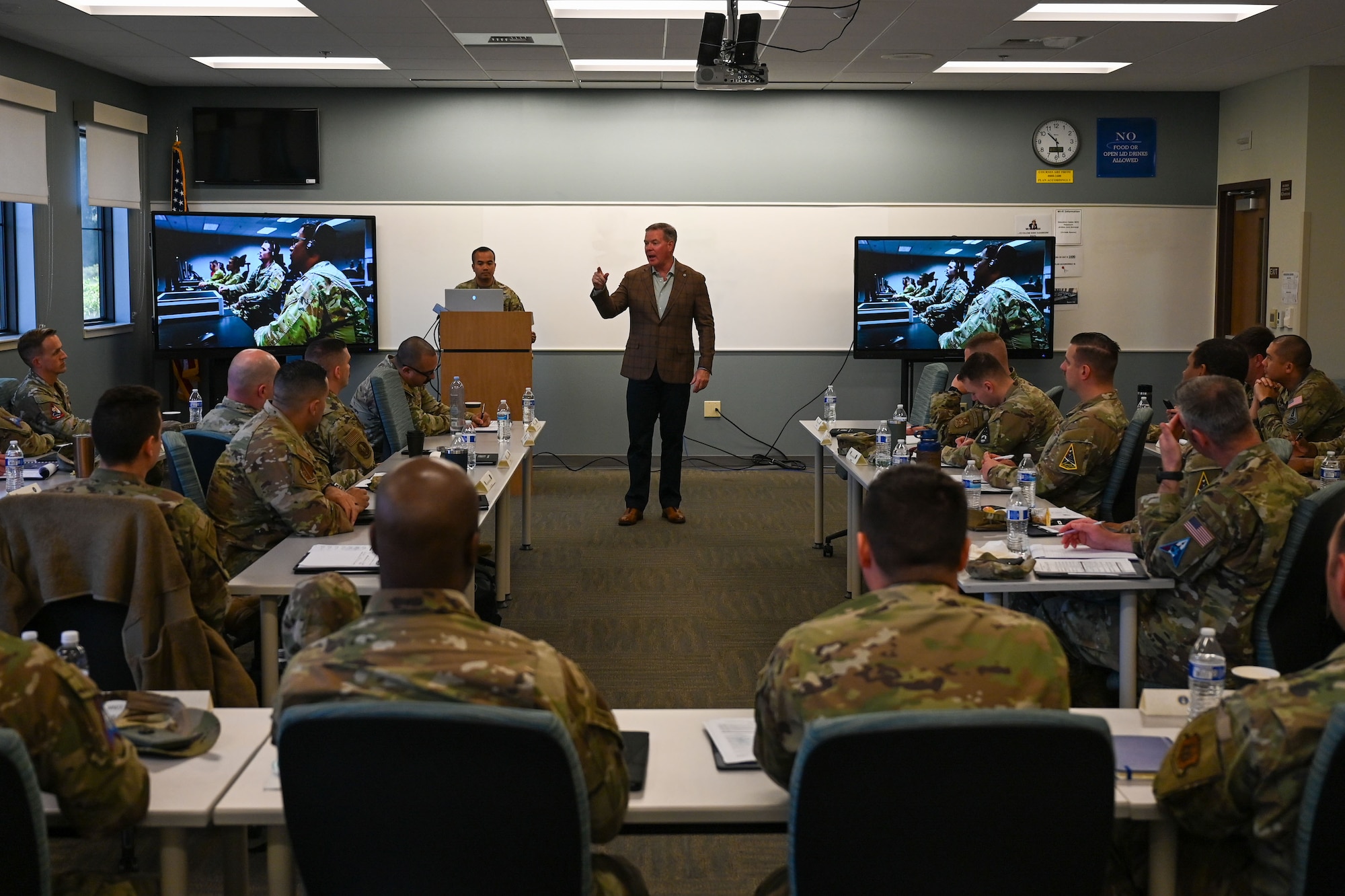 a man speak in a classroom.