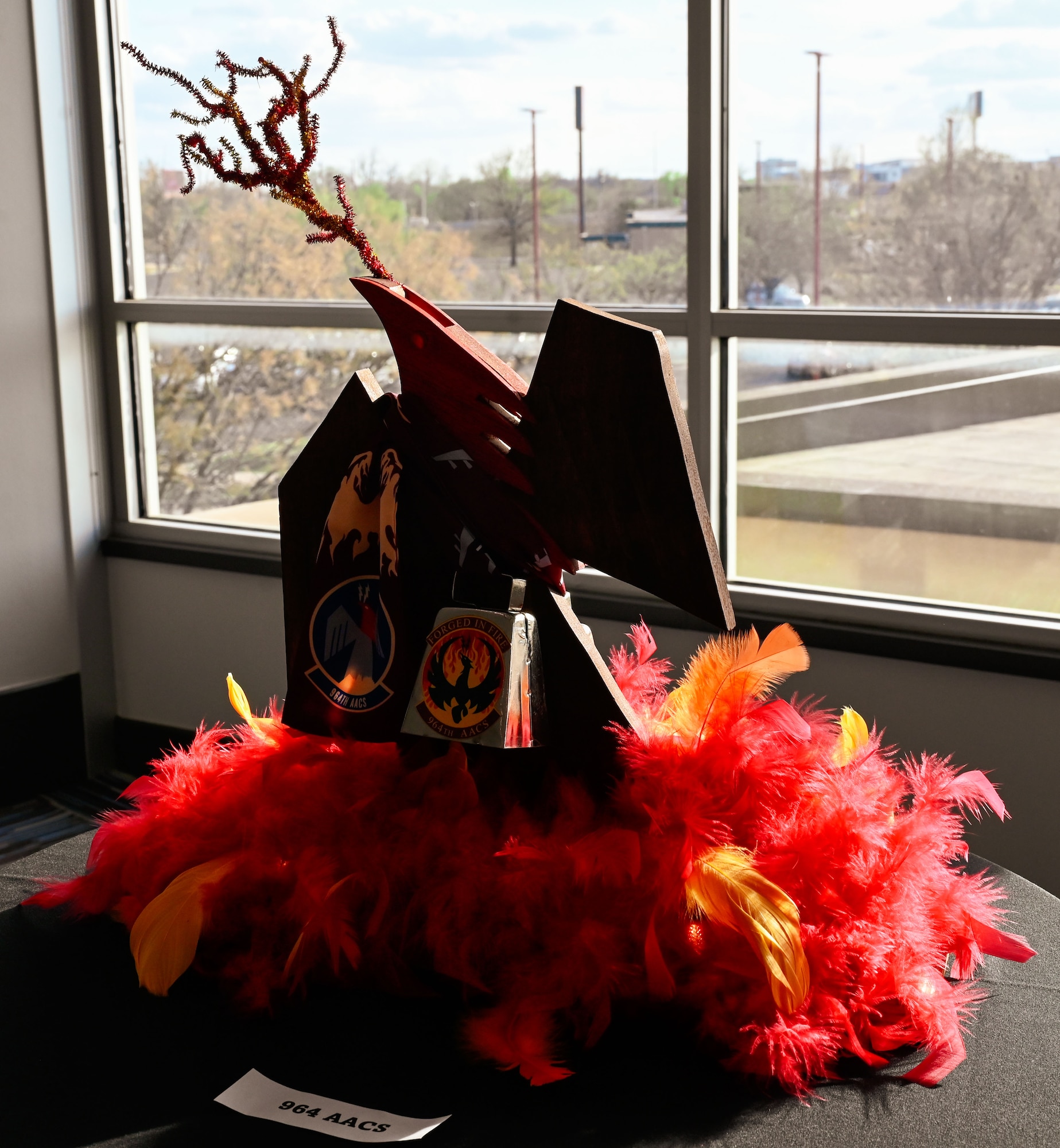 A phoenix-themed display by the 964th Airborne Air Control Squadron adds fiery flair to the 552nd Air Control Wing’s 70th Anniversary Banquet at Tinker Air Force Base, Oklahoma, March 27, 2025. The feathers and flames represent rebirth and enduring strength.
(U.S. Air Force photo by Garrett N. Cole)