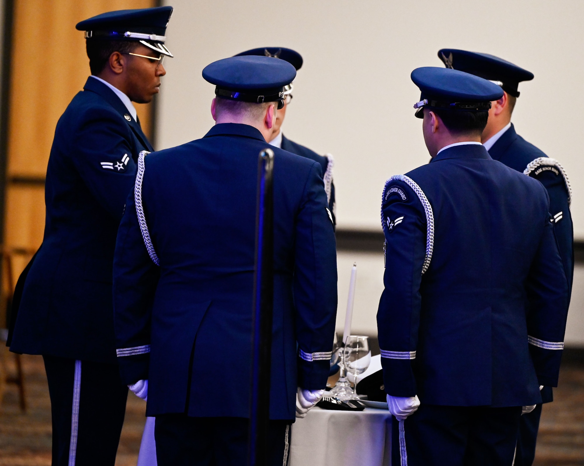 Airmen prepare the table for the missing man ceremony during the 552nd Air Control Wing's 70th Anniversary Banquet. The symbolic act honors fallen, missing or imprisoned service members.
(U.S. Air Force photo by Garrett N. Cole)