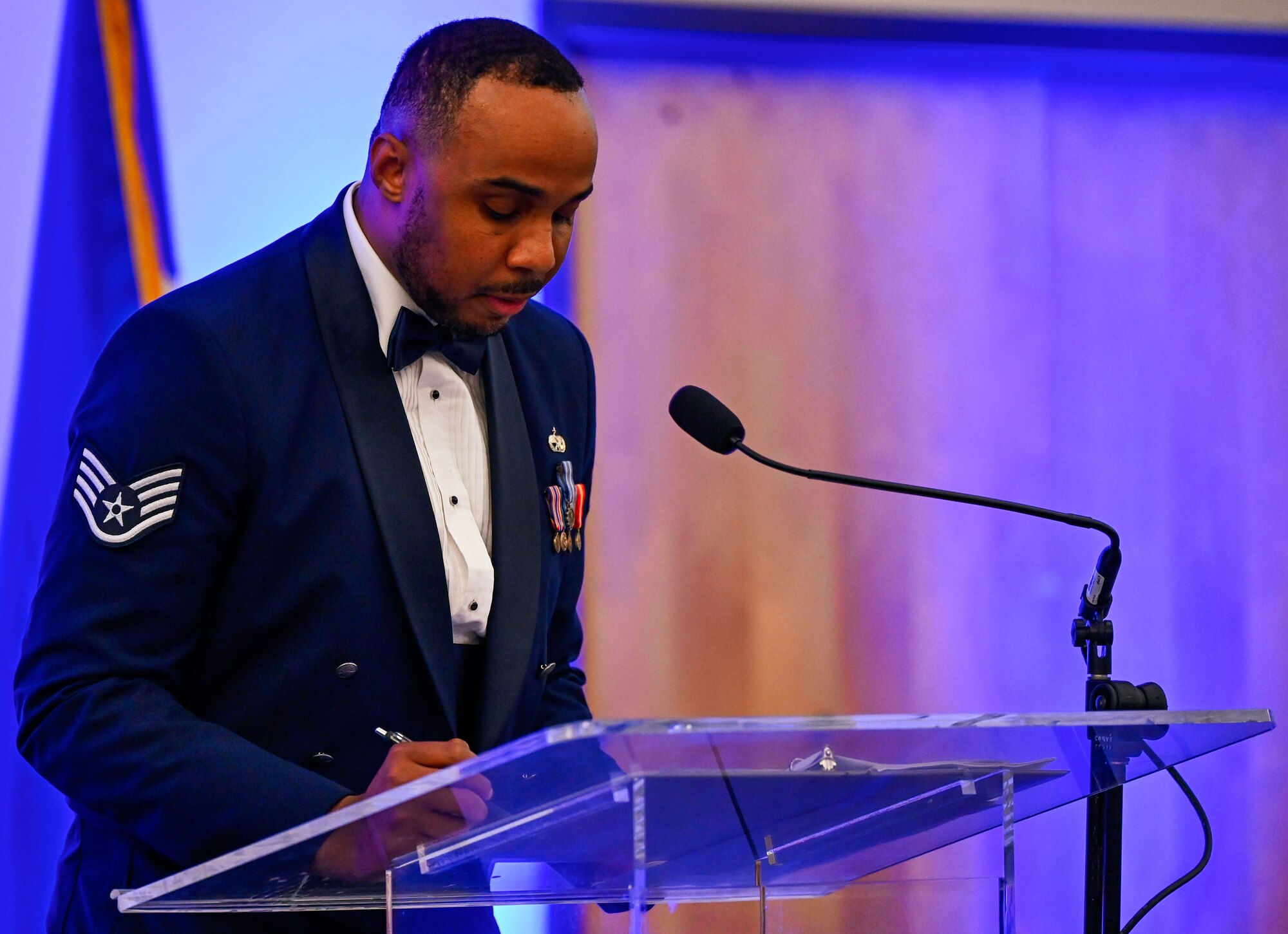 The master of ceremonies of the banquet team reads a script during the 552nd Air Control Wing’s 70th Anniversary Banquet. Ceremonial traditions were carried out with precision and respect.
(U.S. Air Force photo by Garrett N. Cole)