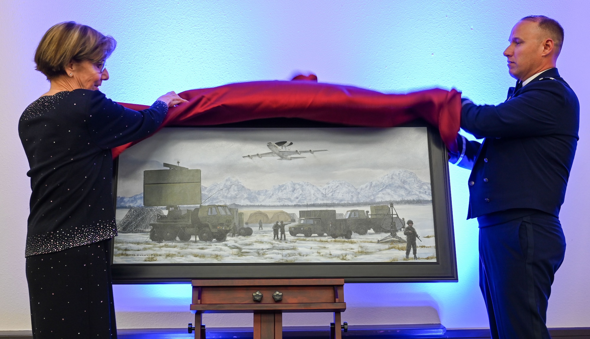 Retired Gen. Lori J. Robinson and Col. Kenneth Voigt unveil a commemorative painting during the 552nd Air Control Wing's 70th Anniversary Banquet.
(U.S. Air Force photo by Garrett N. Cole)
