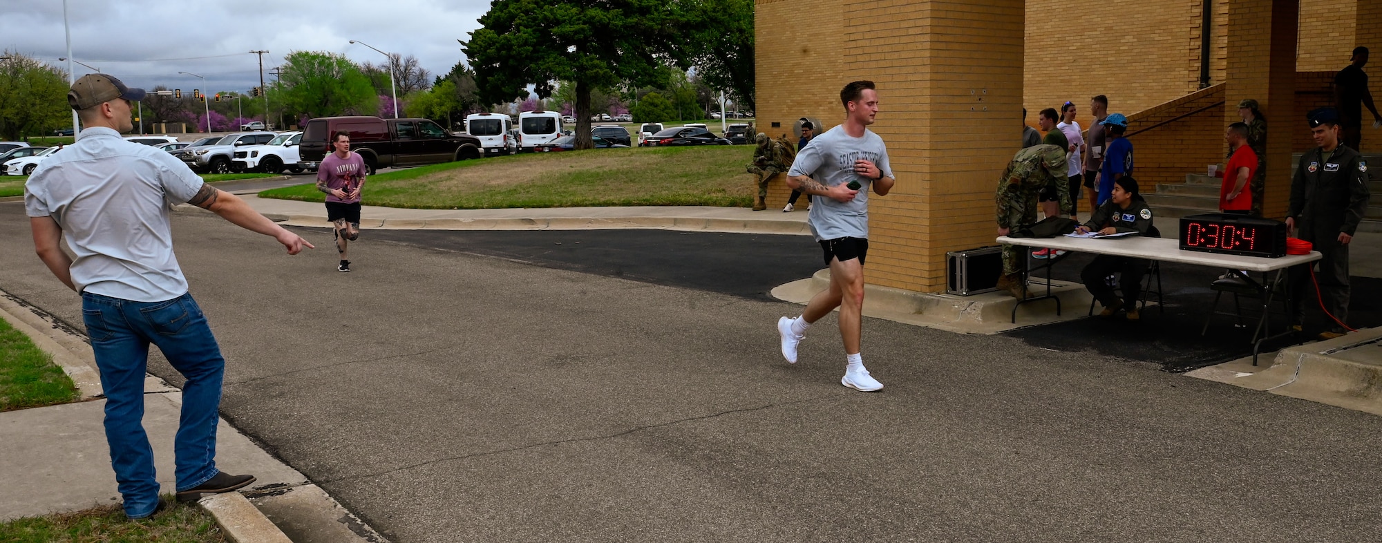 A runner crosses the finish line during the 552nd Air Control Wing’s 5K run at the Tinker Event Center, March 28, part of the wing’s 70th Anniversary celebration. The event promoted fitness and camaraderie among participants.
(U.S. Air Force photo by Garrett N. Cole)