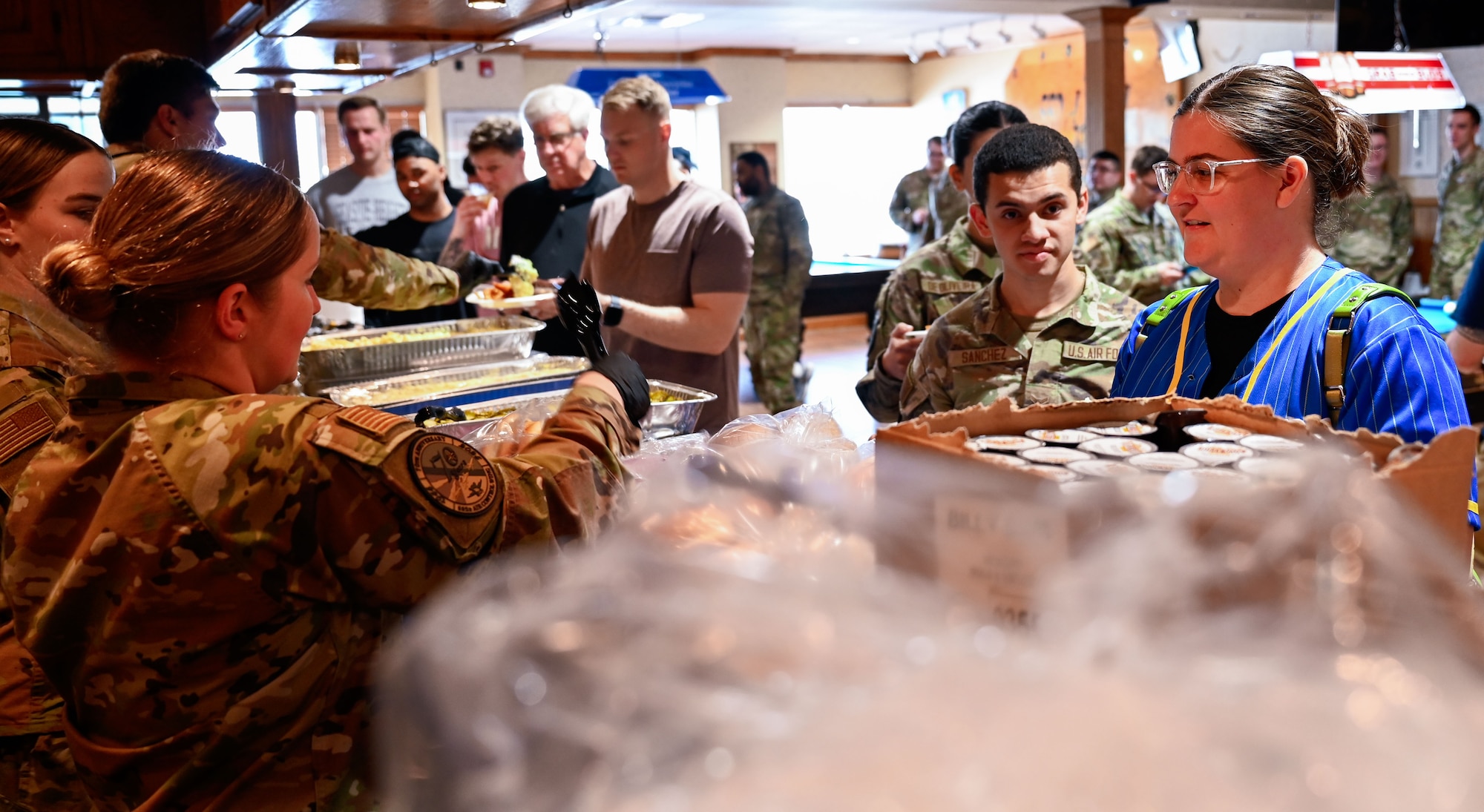 Airmen line up for lunch during the 552nd Air Control Wing’s 70th Anniversary picnic at the Tinker Event Center, March 28. Volunteers served barbecue to attendees in appreciation of their service.
(U.S. Air Force photo by Garrett N. Cole)